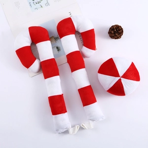 Close-up of red and white striped plush candy cane car decorations with window clips