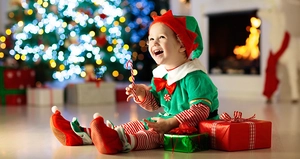 Detailansicht der Weihnachtselfen-Kostüms für Kinder mit gestreifter Hose und grünem Oberteil