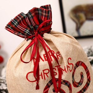 Detail of burlap Christmas candy bag with plaid trim and Merry Christmas embroidery