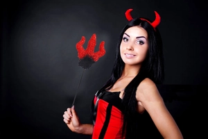 Detail shot of red sequined devil horns headband and matching trident prop for Halloween