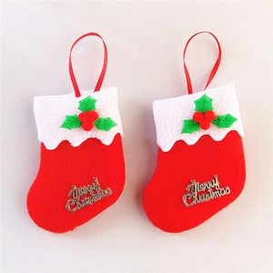 Macro view of small red Christmas stockings with gold Merry Christmas text and white trim