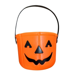 Classic orange Halloween pumpkin candy bucket with black handle and jack-o-lantern face
