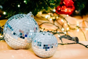 Close-up of sparkling silver mirror disco balls in different sizes with festive background