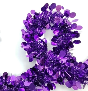 Close-up of vibrant purple tinsel garland with large round metallic sequins for parties