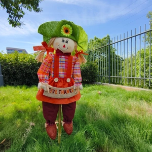 Outdoor scarecrow garden stake with Give Thanks banner and sunflower hat decor