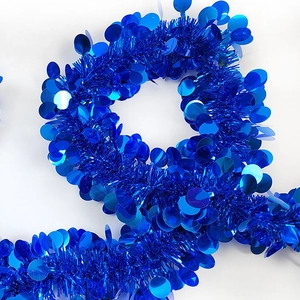 Shiny blue Christmas tinsel garland with large sequins for festive party decoration