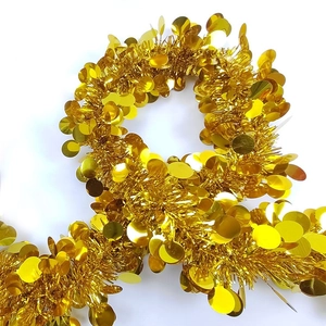 Festive golden tinsel garland with shiny metallic sequins for Christmas party decoration