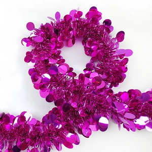 Close-up of sparkling rose red festive tinsel garland with large round metallic sequins