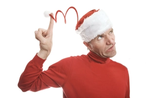 Funny spring Christmas hat with red spiral design and white plush pompom on model
