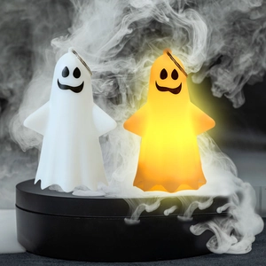 Close-up of glowing Halloween ghost pendant with metal hook on black mist stand