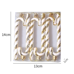 Detail view of 6-piece Christmas candy cane ornaments with gold and white glitter texture