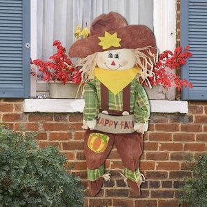 Cute harvest scarecrow with Happy Fall banner for outdoor autumn garden decor