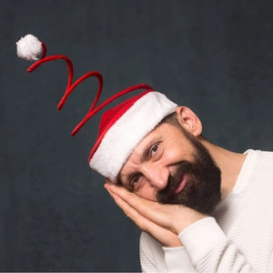 Funny spiral spring Christmas hat with red velvet and white pom-poms on male model