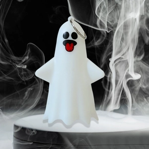 Detailed view of Halloween ghost pendant with a red tongue and a metal loop ring