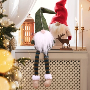 Close-up of plush Christmas gnomes with long striped legs and festive knitted hats