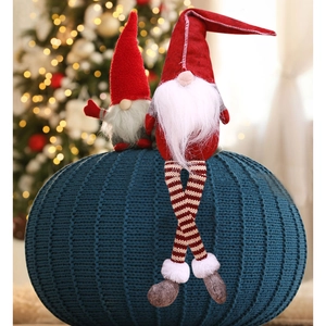 Detail of red and grey Swedish Gnomes with long legs and knitted texture on a dark pouf