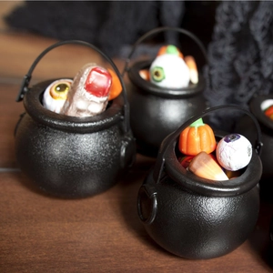 Halloween black witch cauldron candy bucket filled with spooky pumpkins and eyeballs