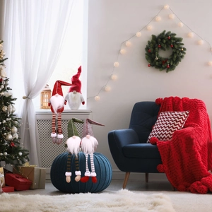 Set of four Nordic Christmas gnomes with long legs in a festive holiday home setting