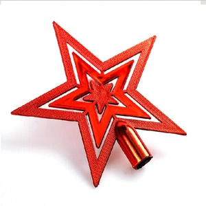Detail view of a 3D red star tree topper with glitter texture and a conical base for trees