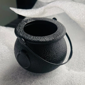 Macro shot of the matte black plastic mini witch cauldron with detailed textured surface