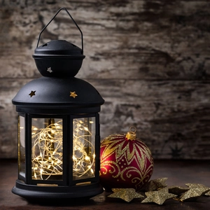 Vintage black metal star lantern with warm LED string lights and Christmas decorations