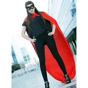 Detail view of long red superhero cape and black butterfly eye mask for cosplay costume