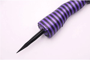 Detail of Halloween witch leg stake with purple stripe fabric and plastic ground plug
