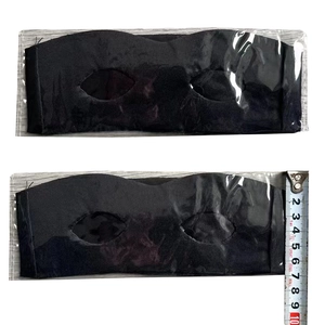 Close-up of black fabric Zorro eye masks in clear plastic packaging with measurement tape