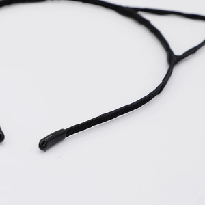 Detail of black satin ribbon wrapped around a cat ear headband with soft protective end caps