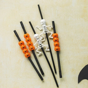 Detail of Halloween party straws featuring orange pumpkin beads and white skeleton figures