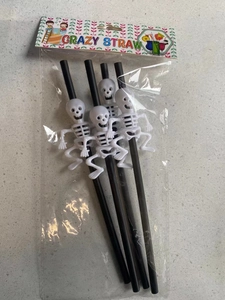 Close-up of Halloween party straws with white skeleton charms in crazy straw packaging