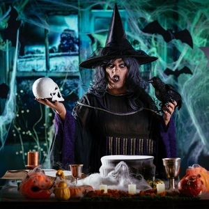 Detailed view of Halloween witch costume with purple sequins and striped skirt