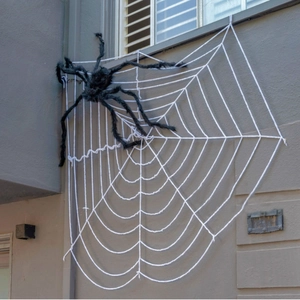 Halloween decoration set featuring a large black plush spider on a giant white outdoor web
