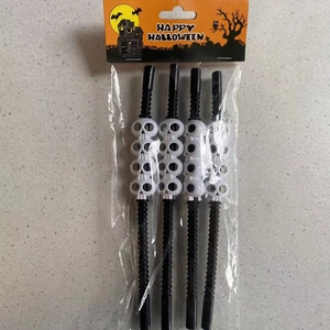 Set of 4 black wavy Halloween party straws with white skull decorations in packaging