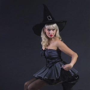Detail of black witch costume with pointed hat and layered tulle tutu skirt for Halloween