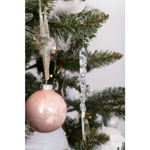 Detail of transparent spiral icicle and matte pink ball hanging on a Christmas tree branch