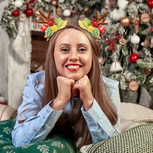 Close-up of a festive reindeer antler hair clip worn by a model in a cozy Christmas setting