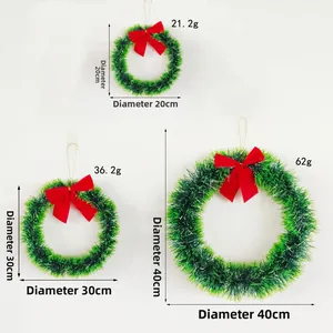 Three sizes of green Christmas wreaths with red bows shown against white background