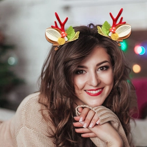 Cute reindeer antler hair clips with mushrooms and forest decor worn by a woman