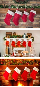 Calze di Natale classiche in peluche rosso appese al camino con calde luci festive