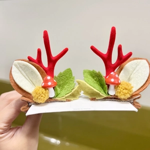 Pair of Christmas reindeer antler hair clips with cute mushroom and leaf details