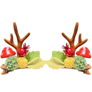 Pair of Christmas reindeer antler hair clips with cute mushrooms and berries decorations
