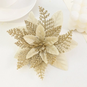 Macro shot of gold artificial Christmas flower head with glitter and satin petal details