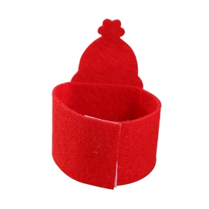 Macro view of the red felt Santa Claus napkin ring with festive hat-shaped top decoration