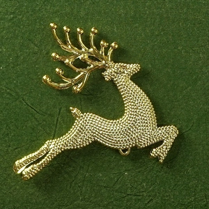 Detail view of champagne gold metal reindeer pendant with matte finish and hanging loop