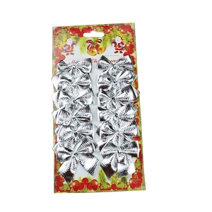 Set of 12 glossy silver Christmas bows on festive red and green decorative card