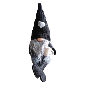 Knitted Christmas gnome doll with heart hat holding a cup for holiday home decoration