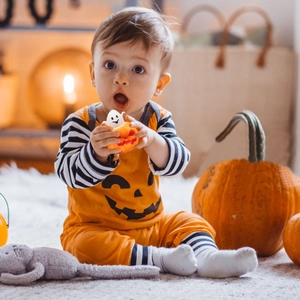Halloween squeeze toy featuring a cute white ghost popping out of an orange pumpkin