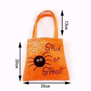 Detail view of orange Halloween treat bag with spider web design and 20cm size markings