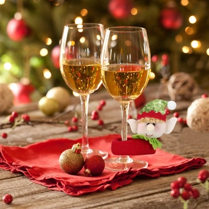 Detail of sequined Christmas elf wine glass covers on a festive holiday dinner table